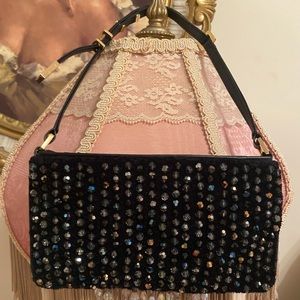 Swarovski black leather beaded mini bag with an adjustable strap.